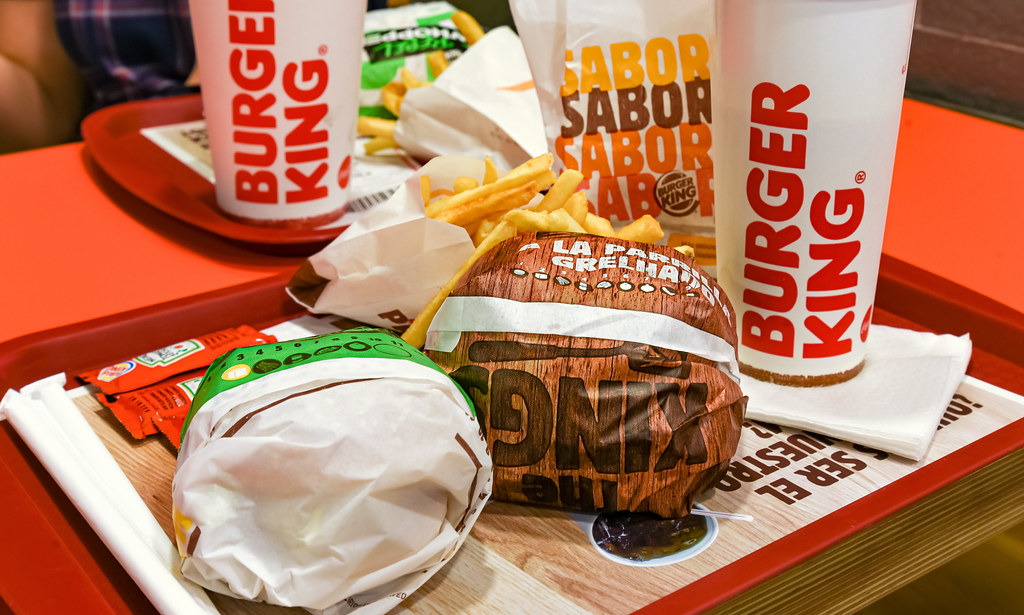Red Burger King tray with fries, Whopper and drinks.
