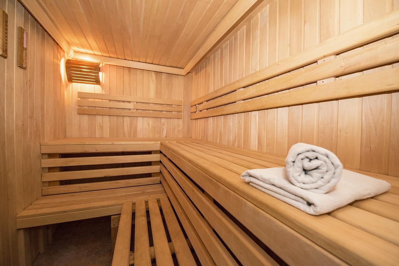Empty sauna made of wood with towel.