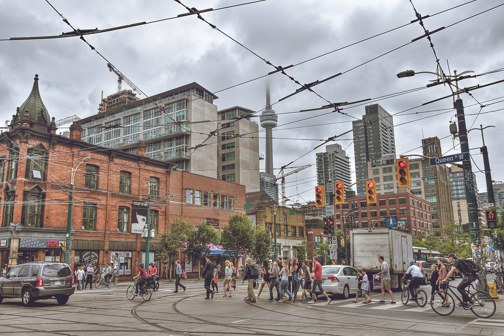 Pedestrians crossing street in Queen West in Trinity Bellwoods.