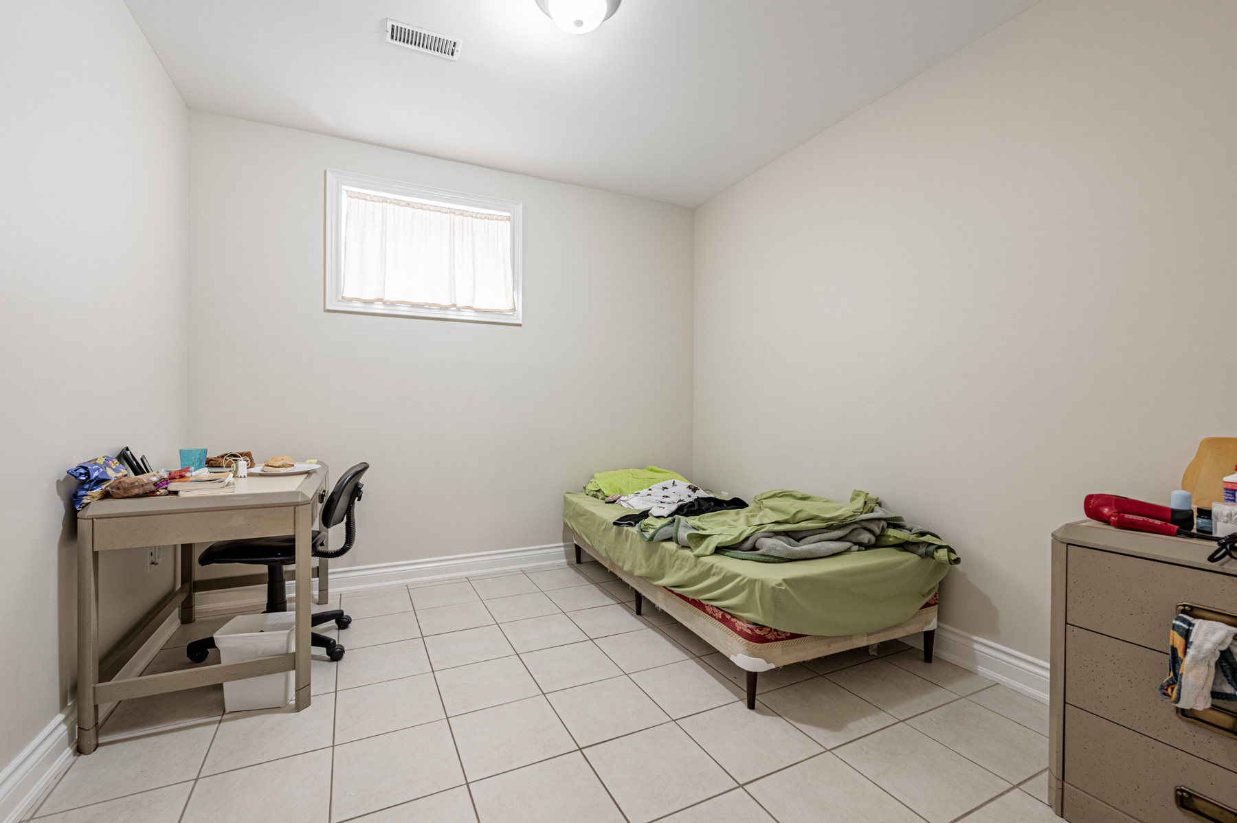 Large, well-lit basement bedroom.