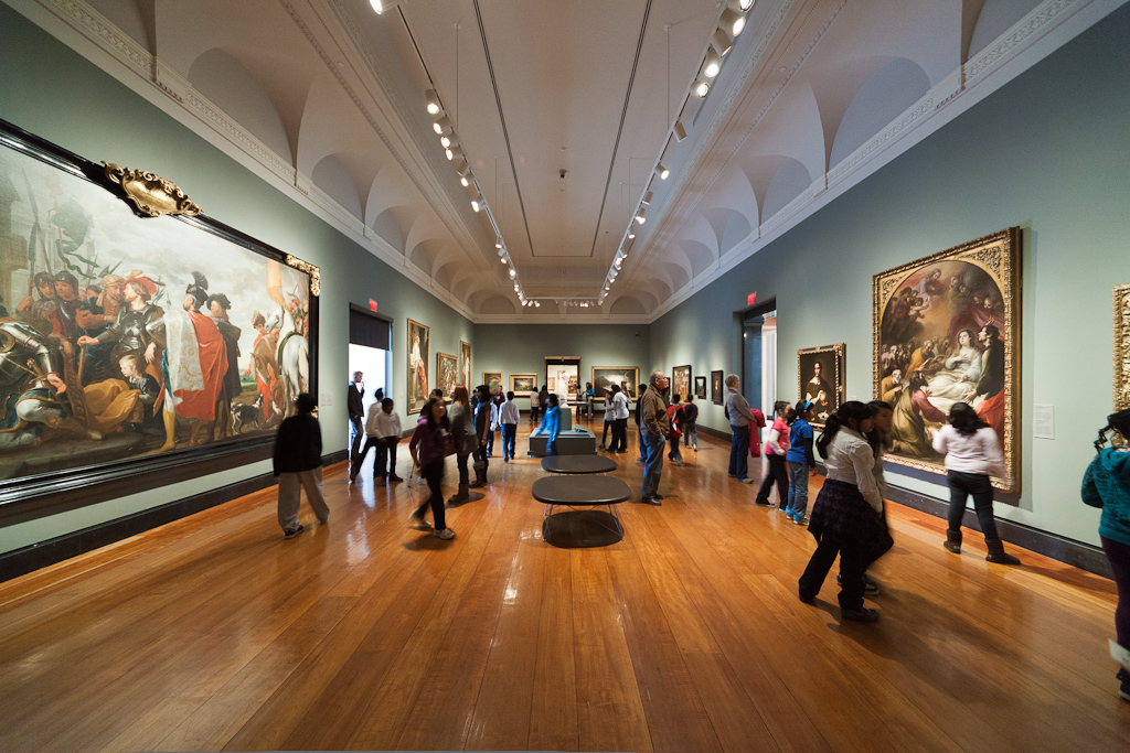 People looking at paintings at the Art Gallery of Ontario.