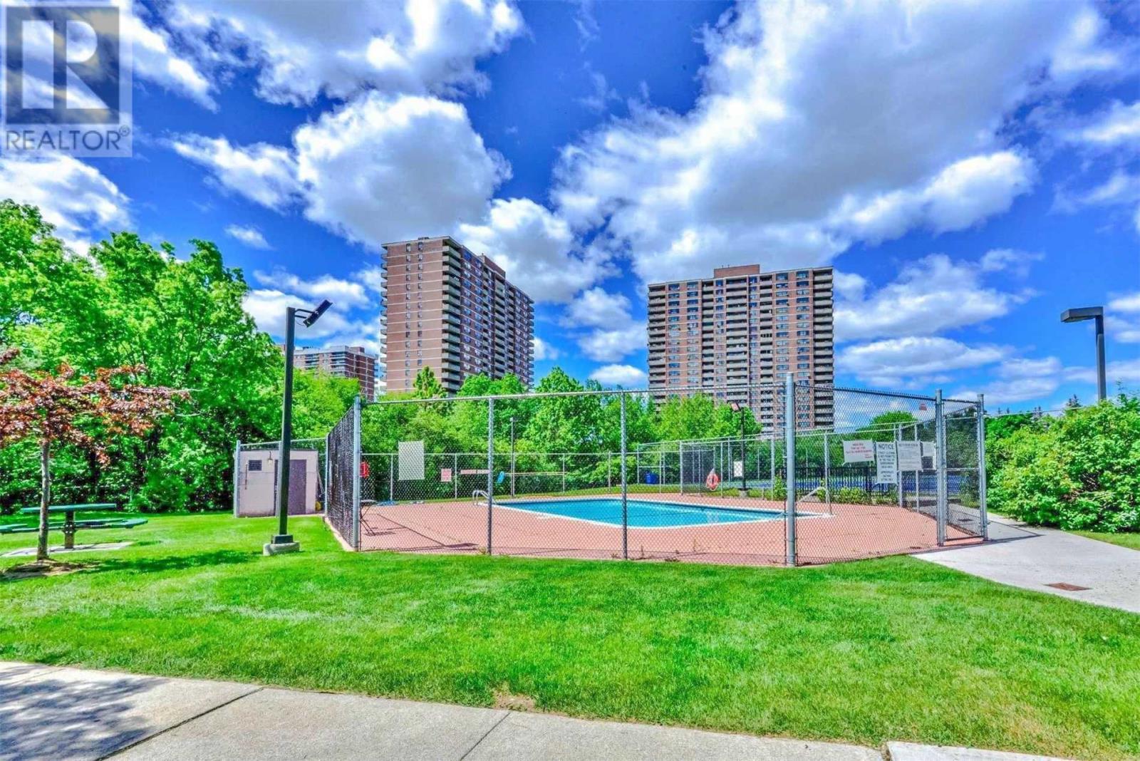 Fenced swimming pool amenity at Platinum on the Humber condos.