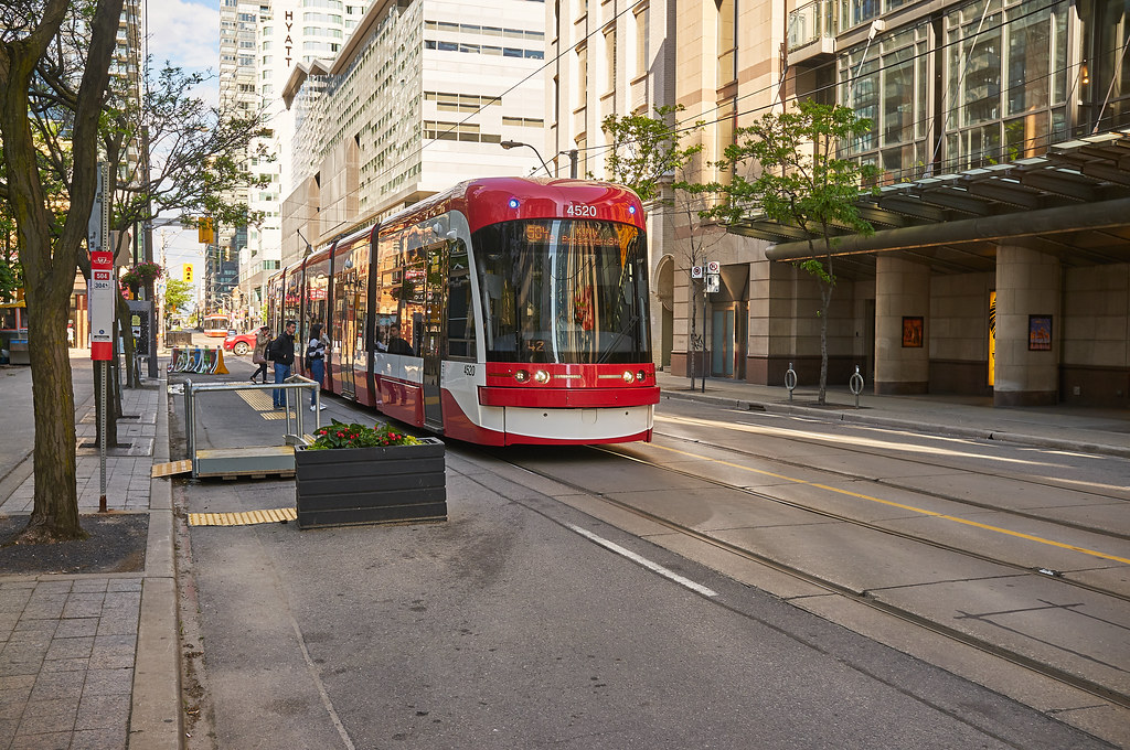 People boarding red Toronto streetcar.