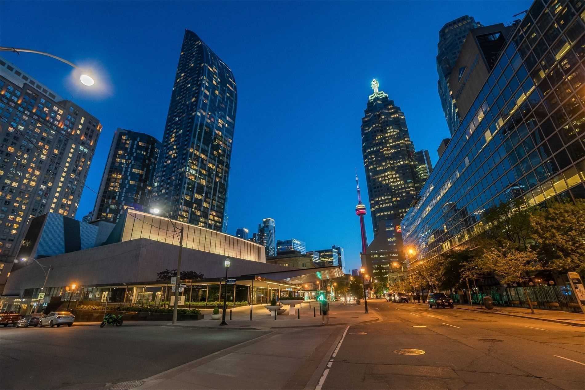Night view of streets of St. Lawrence neighbourhood, including CN Tower.