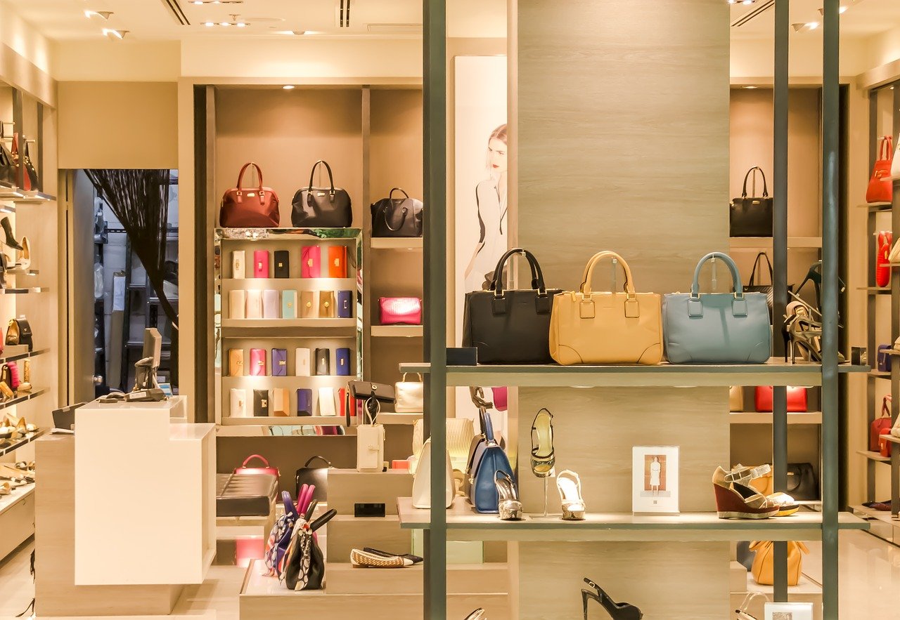 Store window with upscale shoes and purses.