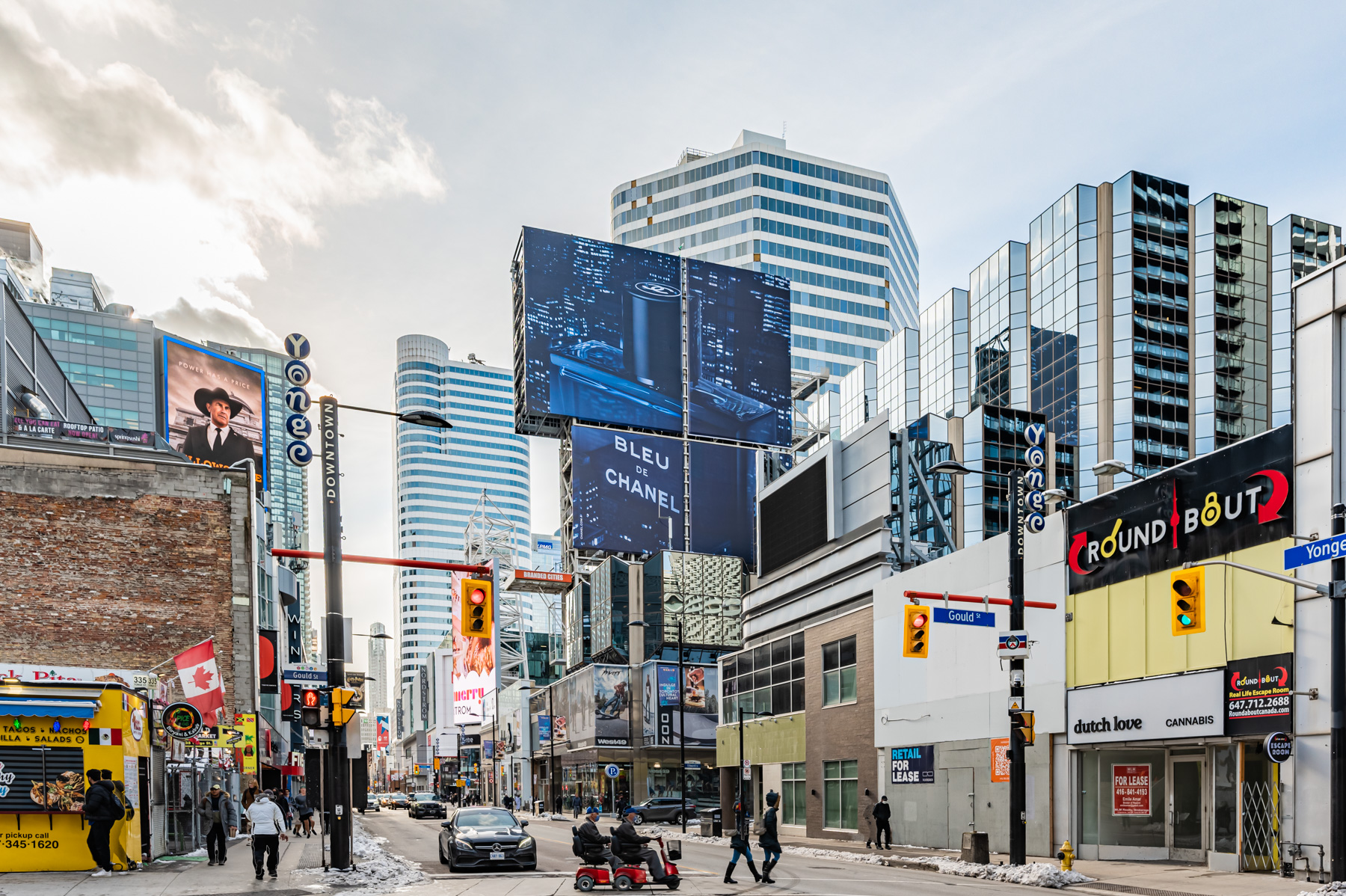 People, pedestrians, cars and shop fronts along Yonge and Dundas, Toronto.