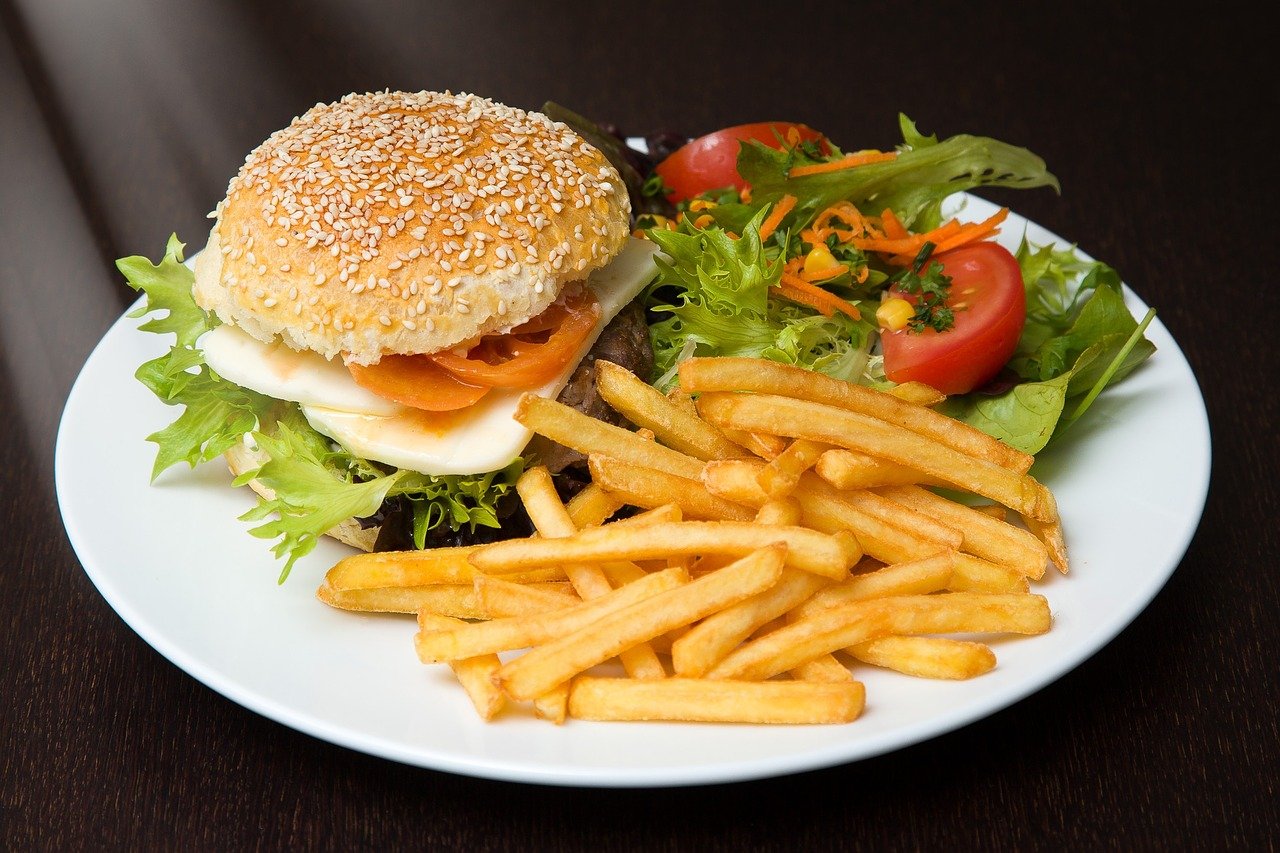 Plate with burger, fries and salad.