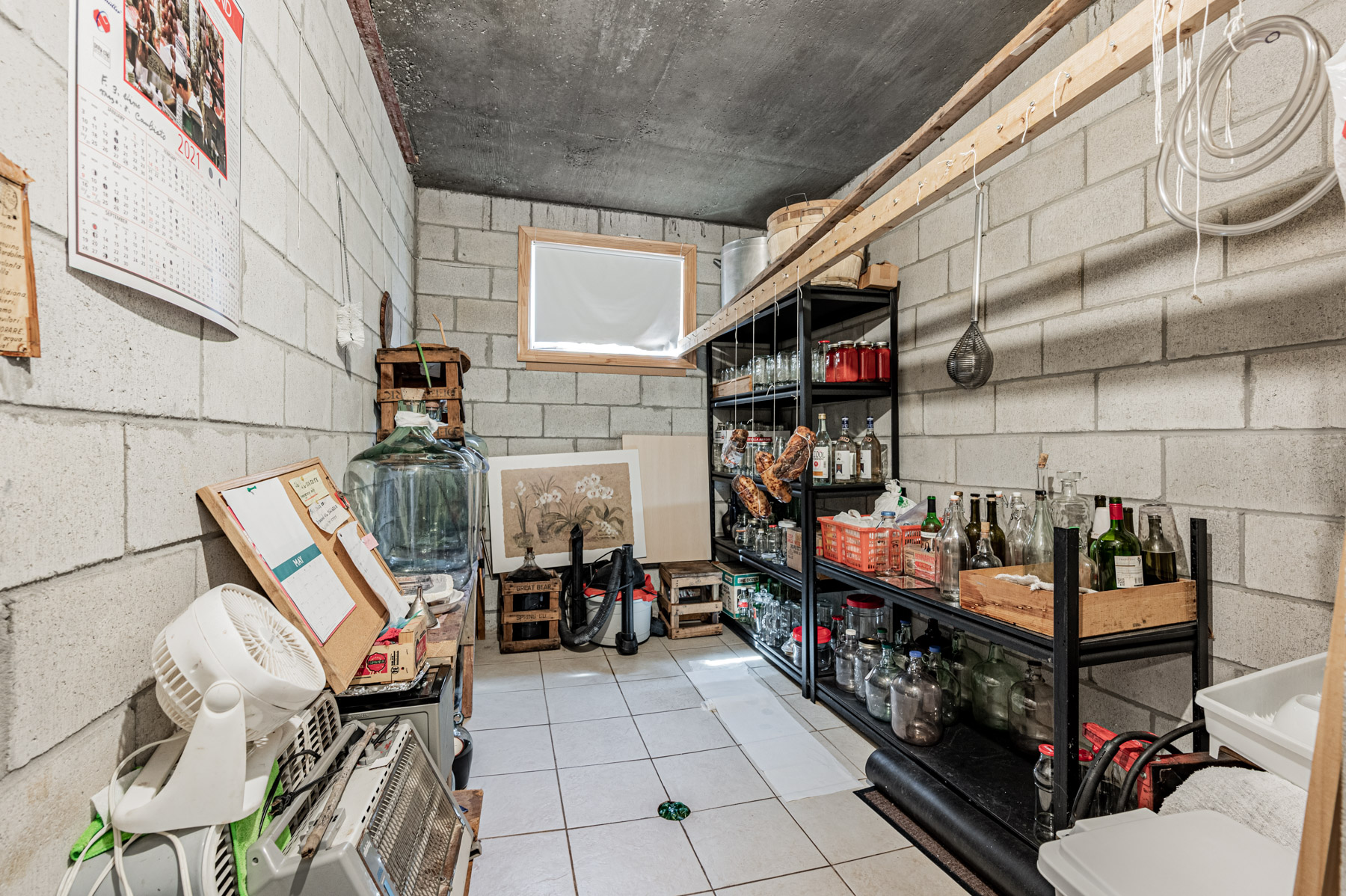 Cold storage room with bottles of alcohol and other items.
