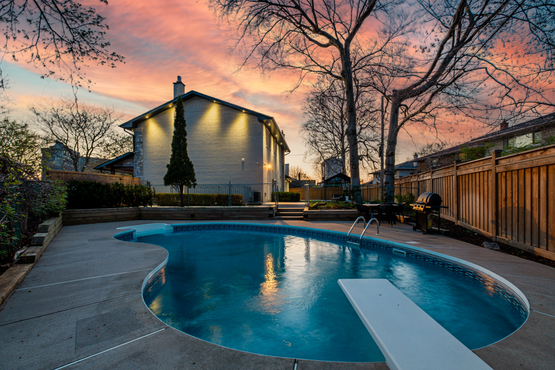 3 Logwood Court backyard illuminated by LED pot-lights during evening.