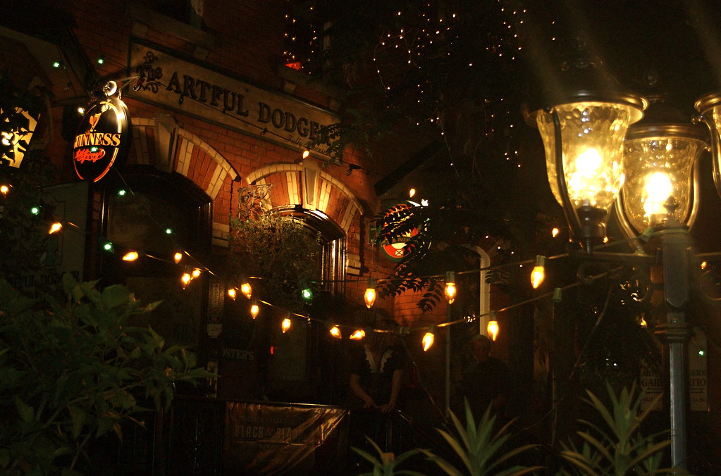 Artful Dodger pub brown brick exterior at night on Yonge and Bloor.