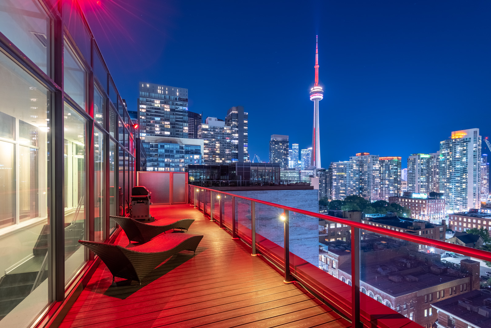 Photo of CN Tower and Toronto at night from Victory Lofts Penthouse Suite in 478 King St W Toronto.