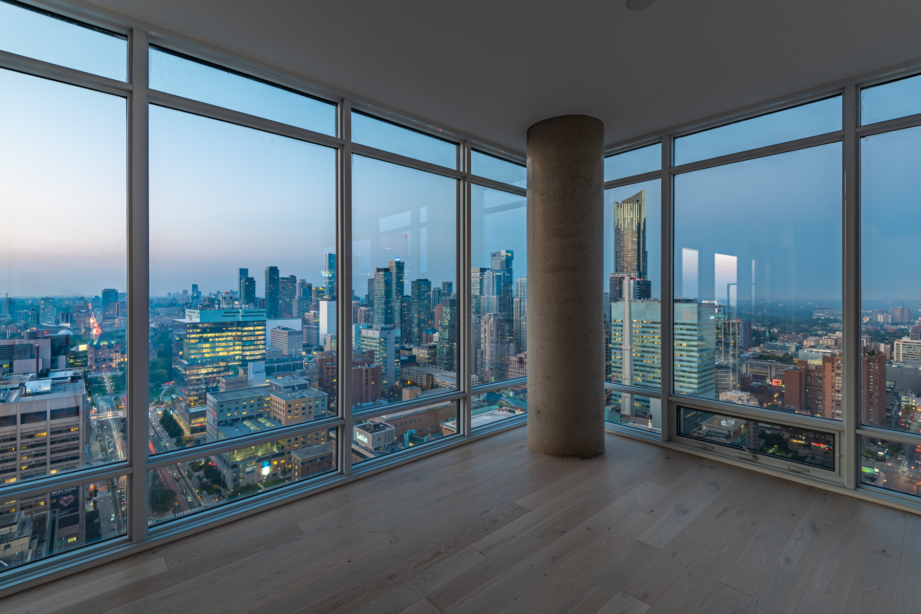 488 University Ave Unit 3102 living room with view of Toronto through windows.