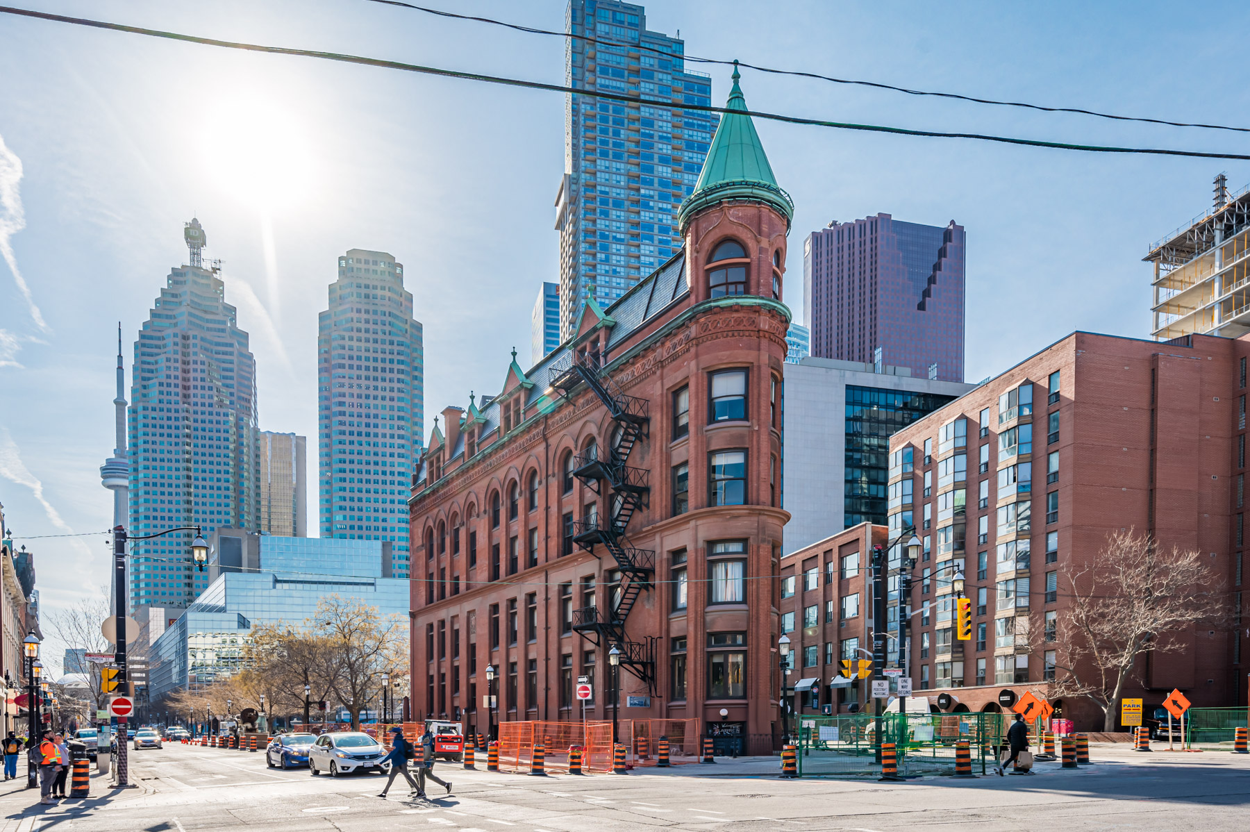 The Gooderham red brick flatiron building in Toronto with CN Tower in background.