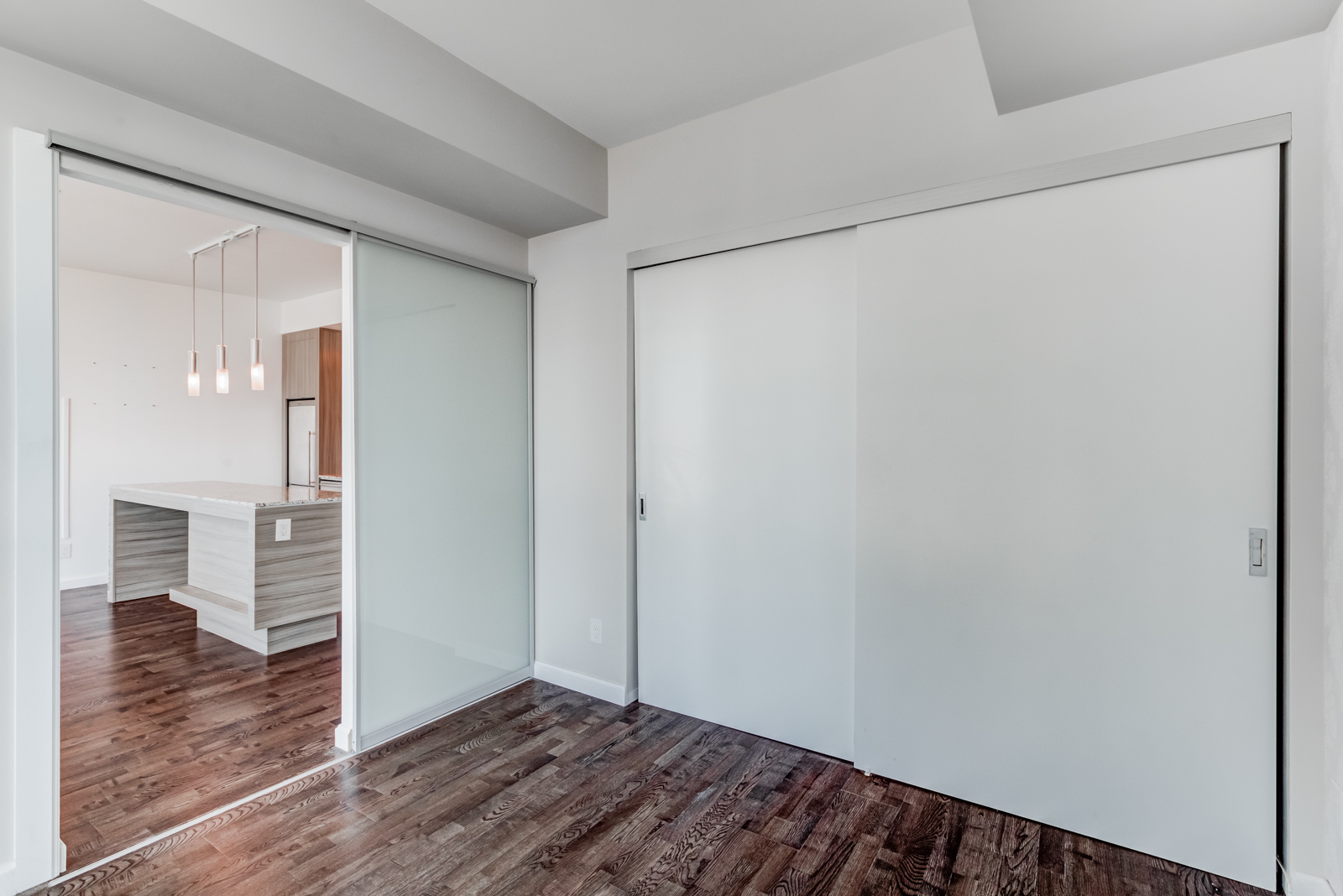 Master bedroom closet with dual gray sliding doors.