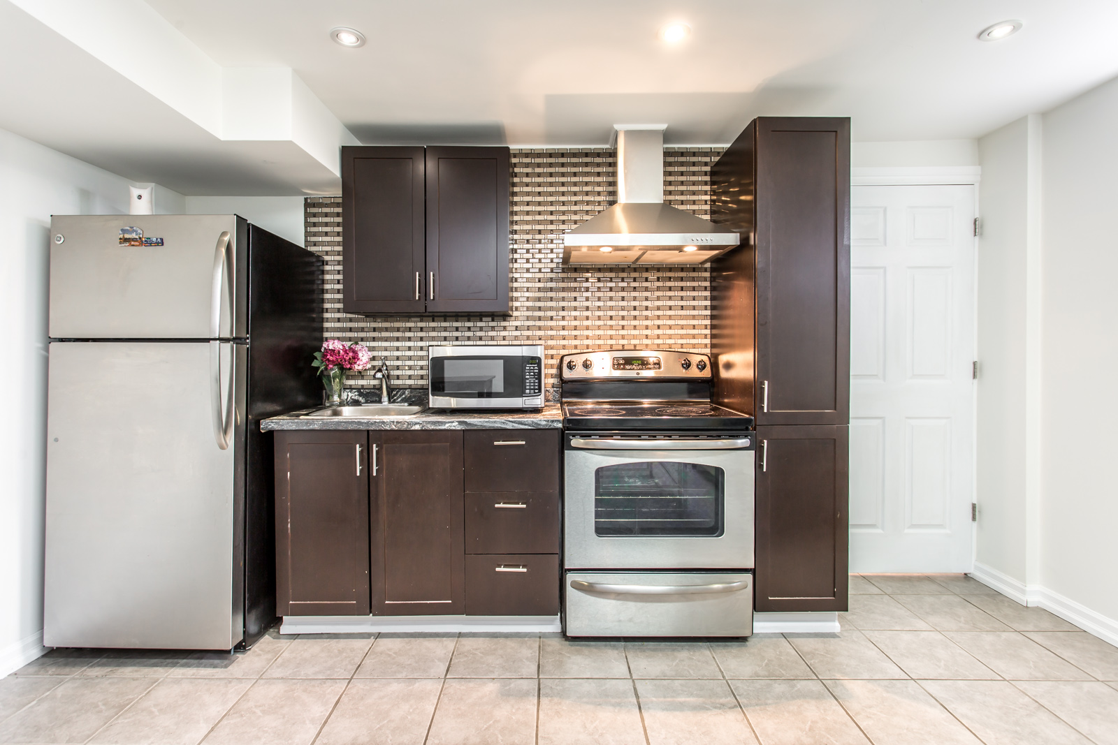 9 Keywest Avenue kitchen showing appliances and dark wooden cabinets. Third, therefore, in conclusion seems like, maybe, probably, almost done.