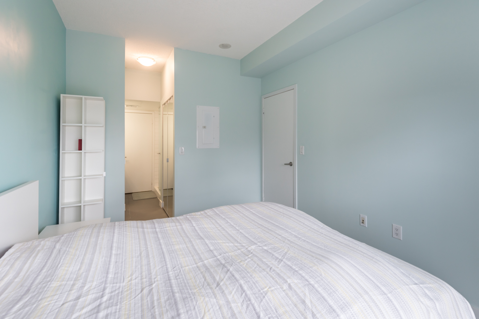 Another side of the bedroom. We see the closet and also the bathroom door.