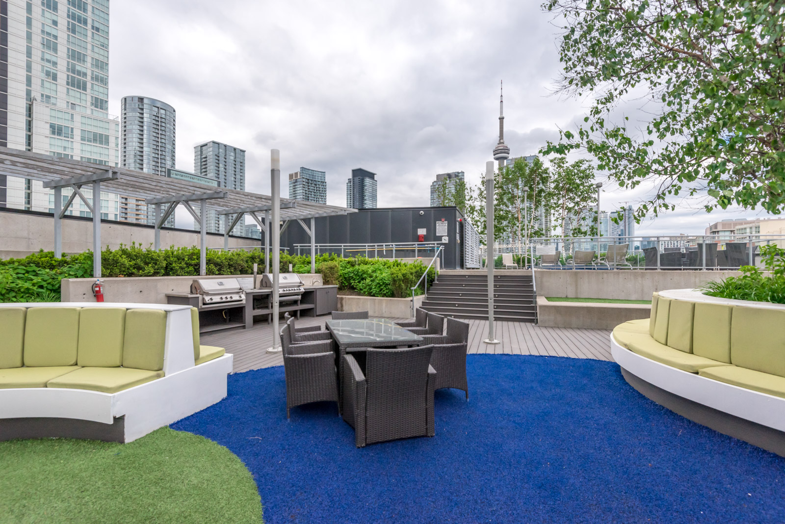 Outside view showing rooftop and chairs and CN Tower in the background.