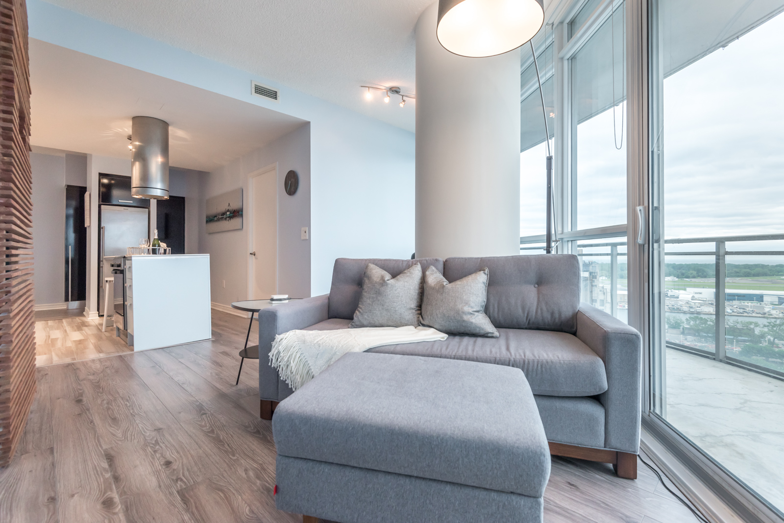 Image of condo's rather tall ceilings and we also see kitchen in background.