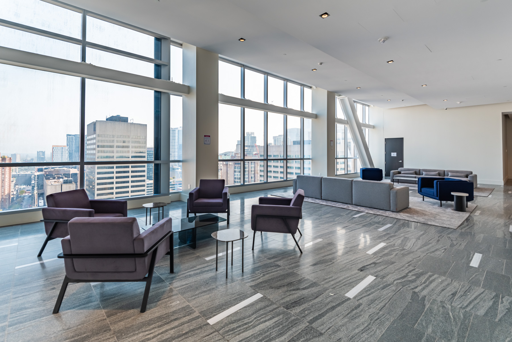 Visitor lounge at 488 University Ave with sofas and tables.