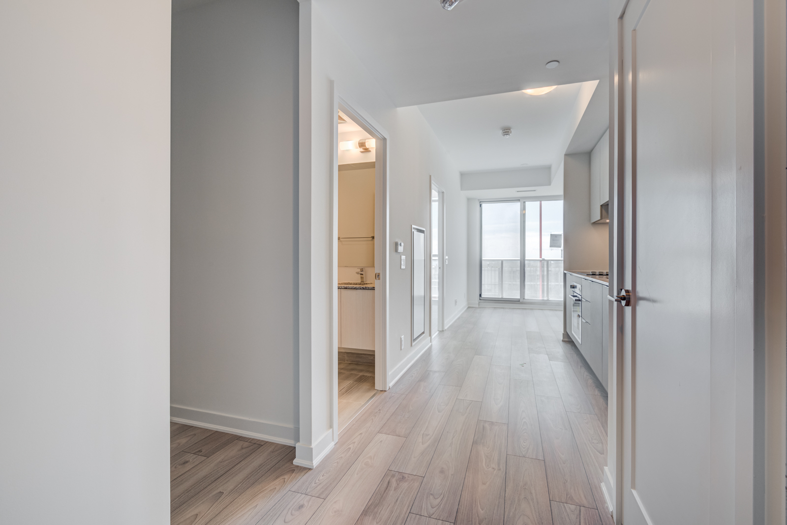 View of 120 Parliament St's linear kitchen and living room.