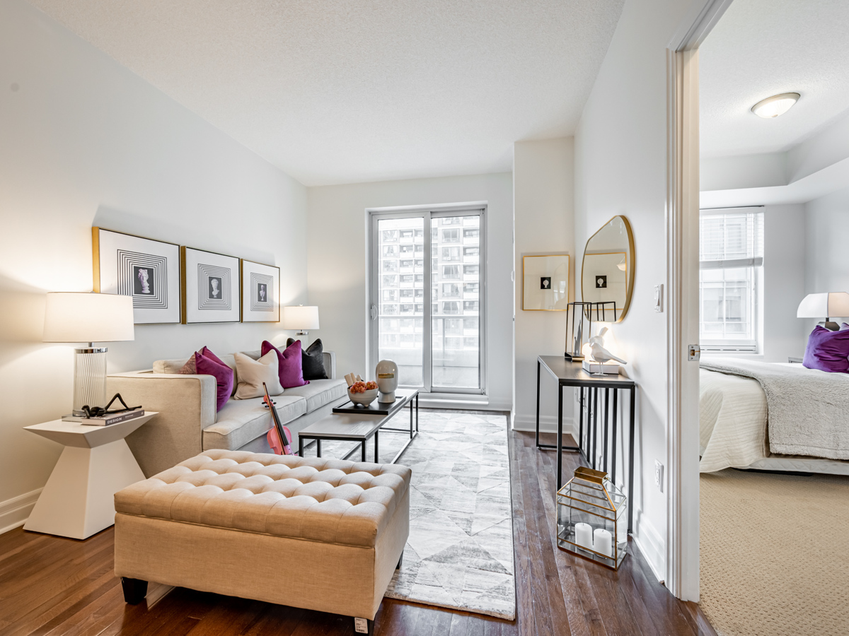 Condo living room lit by balcony.