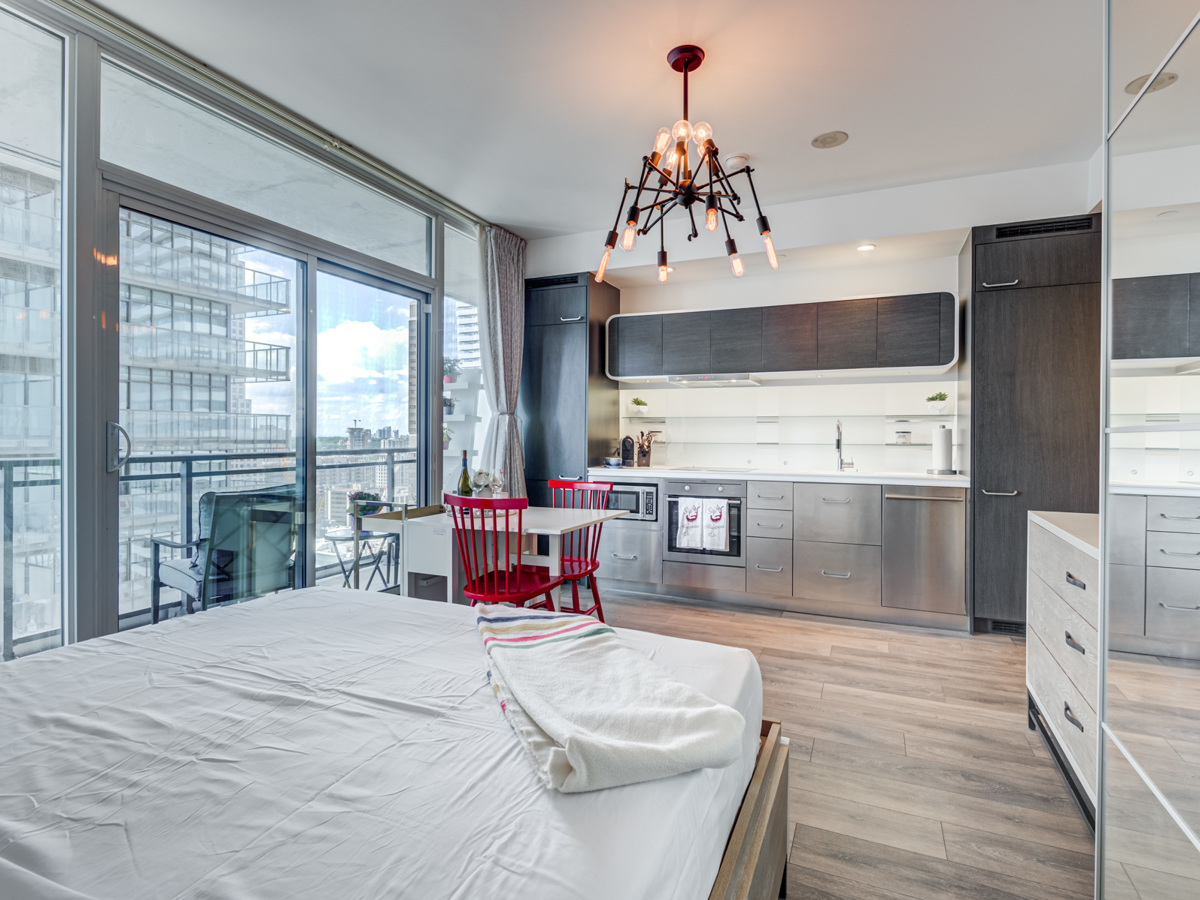 Bachelor's apartment with huge windows and stylish chandelier.