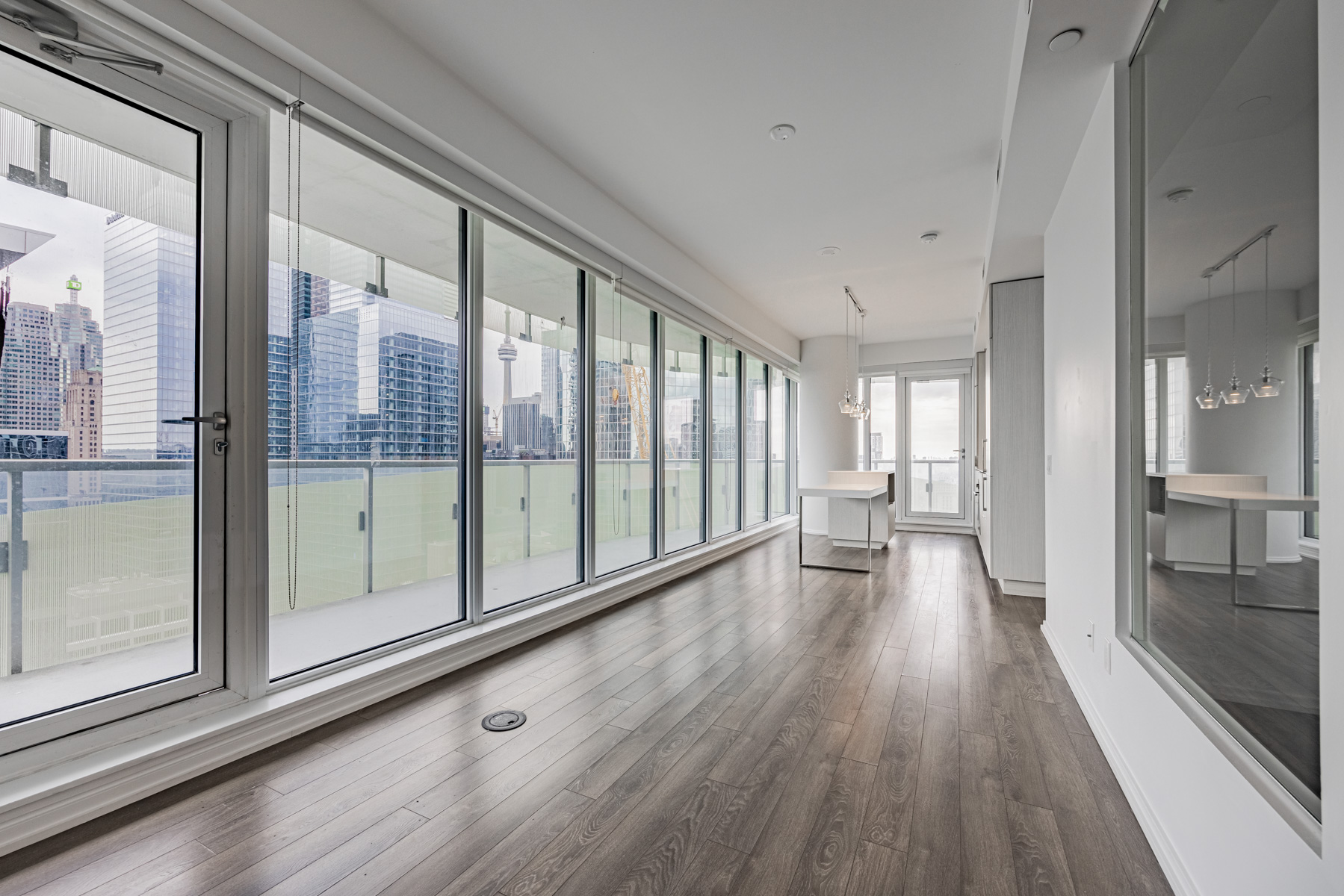 197 Yonge St Unit 2209 living room and kitchen with large glass windows.