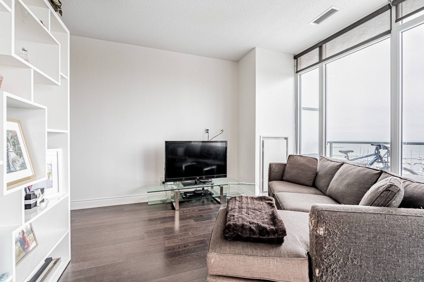 Large windows lighting up condo living room.