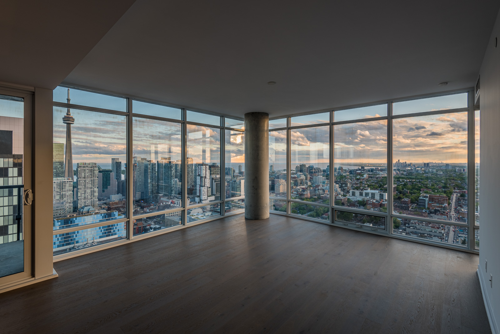 Empty condo and view of Toronto from 488 University Ave Unit 3410 living room.