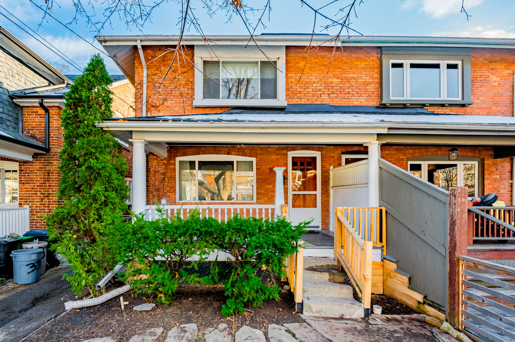 Red brick exterior of 35 Woburn Ave, a 2-storey semi-detached house.