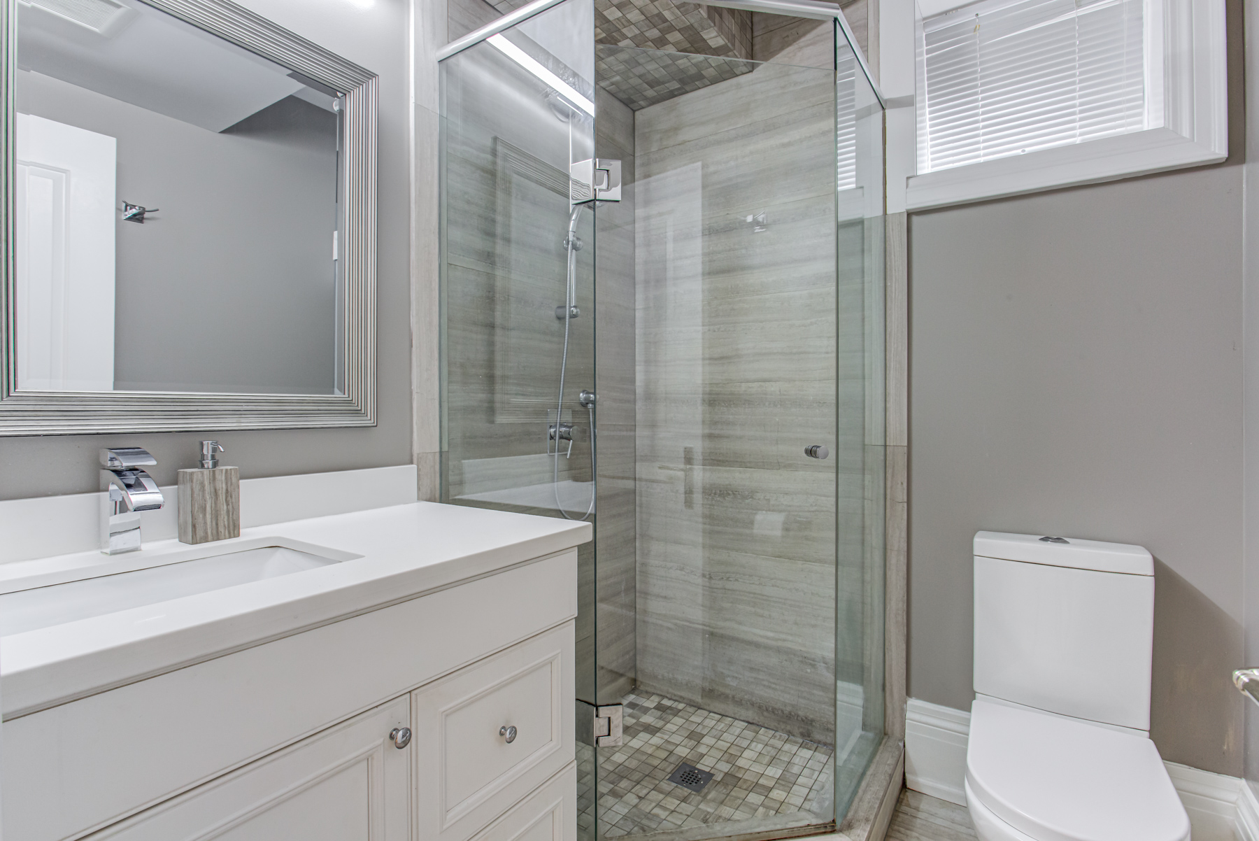 741 Glencairn Ave basement shower with quartz counters, marble tiles and glass shower doors.