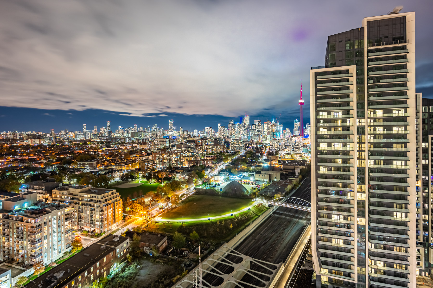 View of Toronto at night thru bedroom of 19 Western Battery Rd Unit 2921.