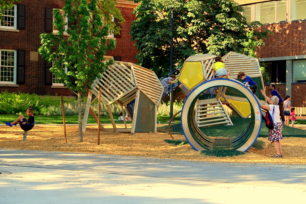 Kids playing on colourful playground equipment at Grange Park.