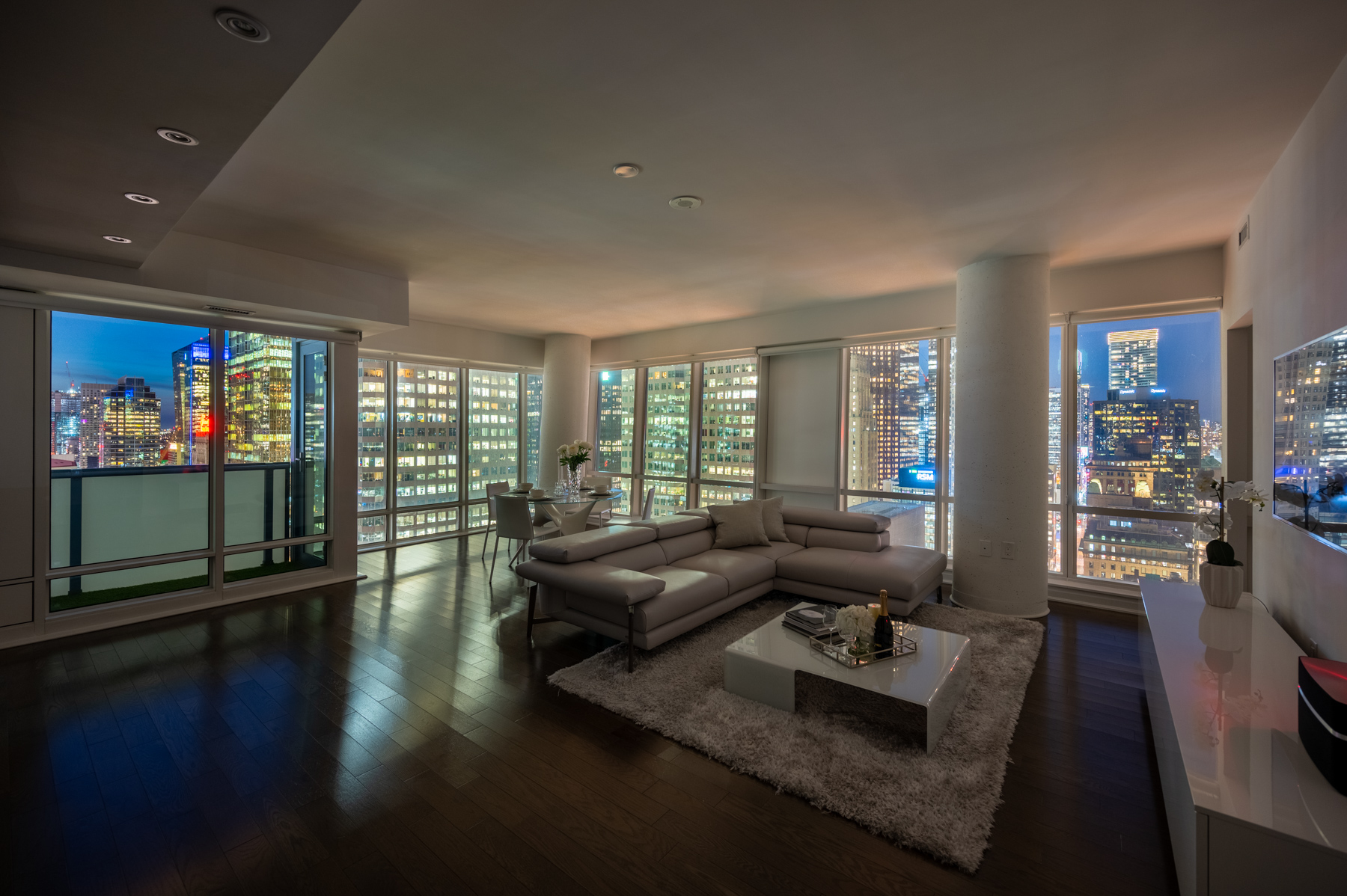 Condo living room lit by light from buildings.