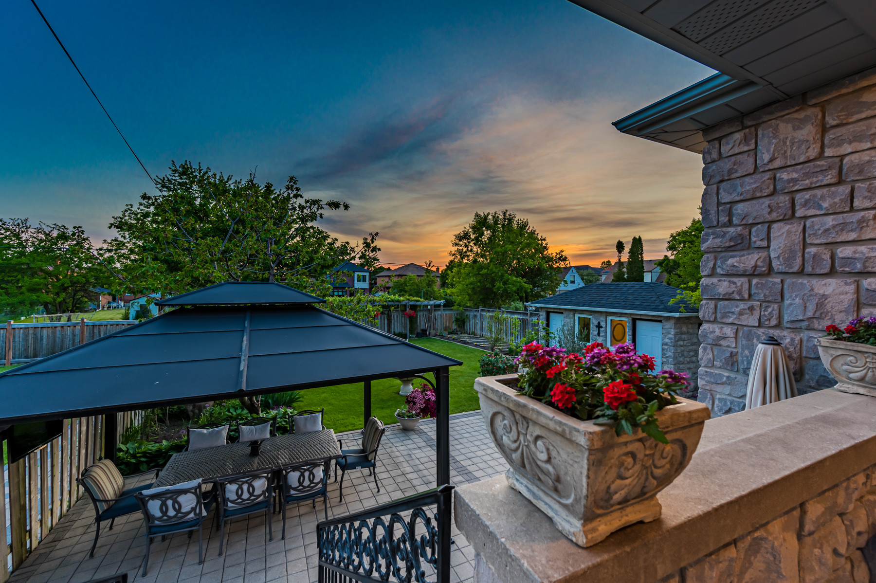 Sun setting over trees, as seen from backyard of 12 Highland Hill.