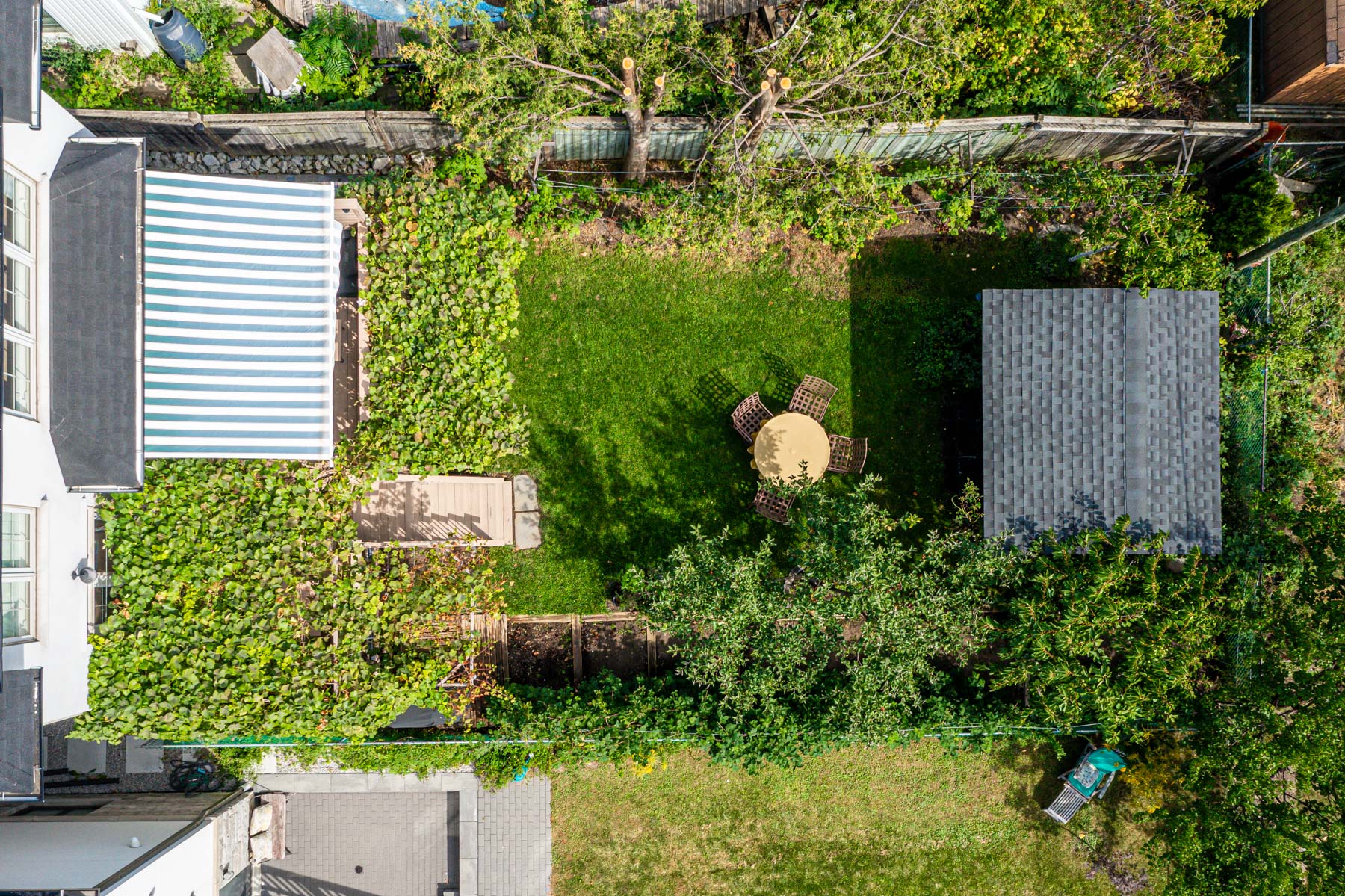 Aerial drone photo of 741 Glencairn Ave lush backyard with deck and shed.