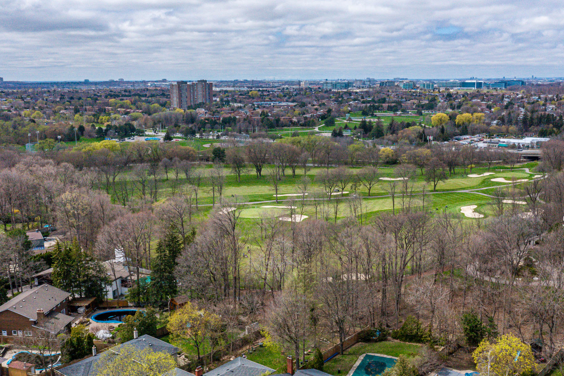 Aerial shot of Markland Wood Golf Course showing trees, fairway, houses and buildings.