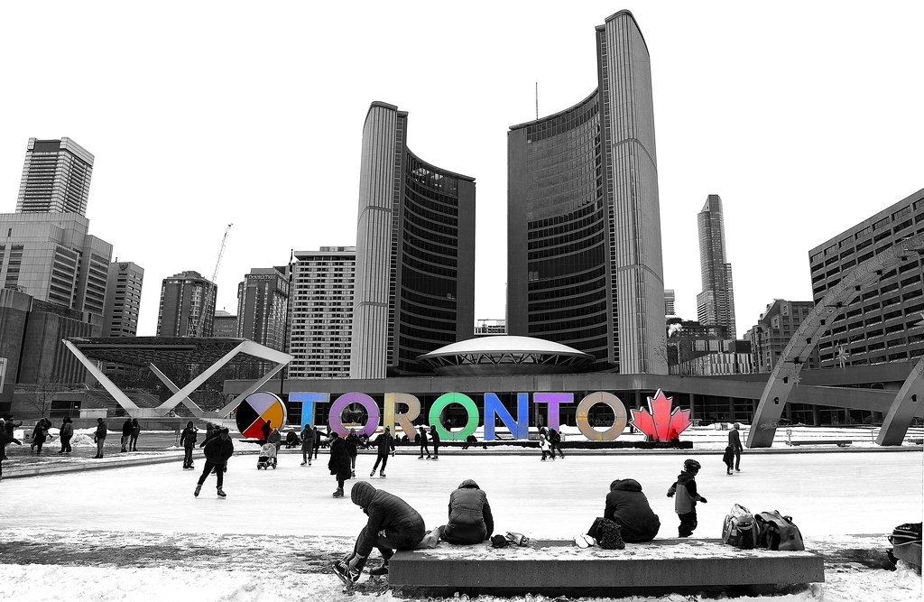 People skating at Nathan Philips Square in winter.