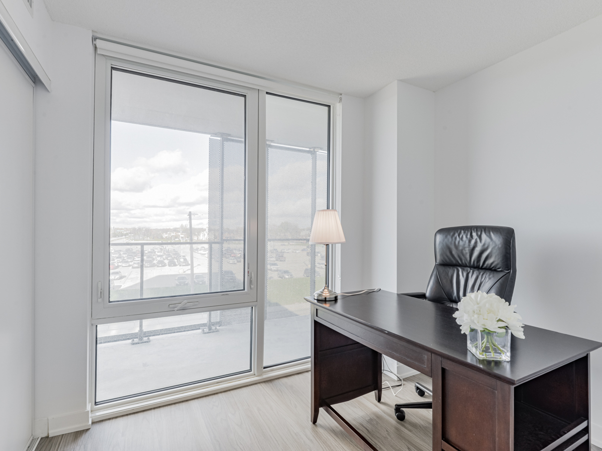 Condo home office with large windows.