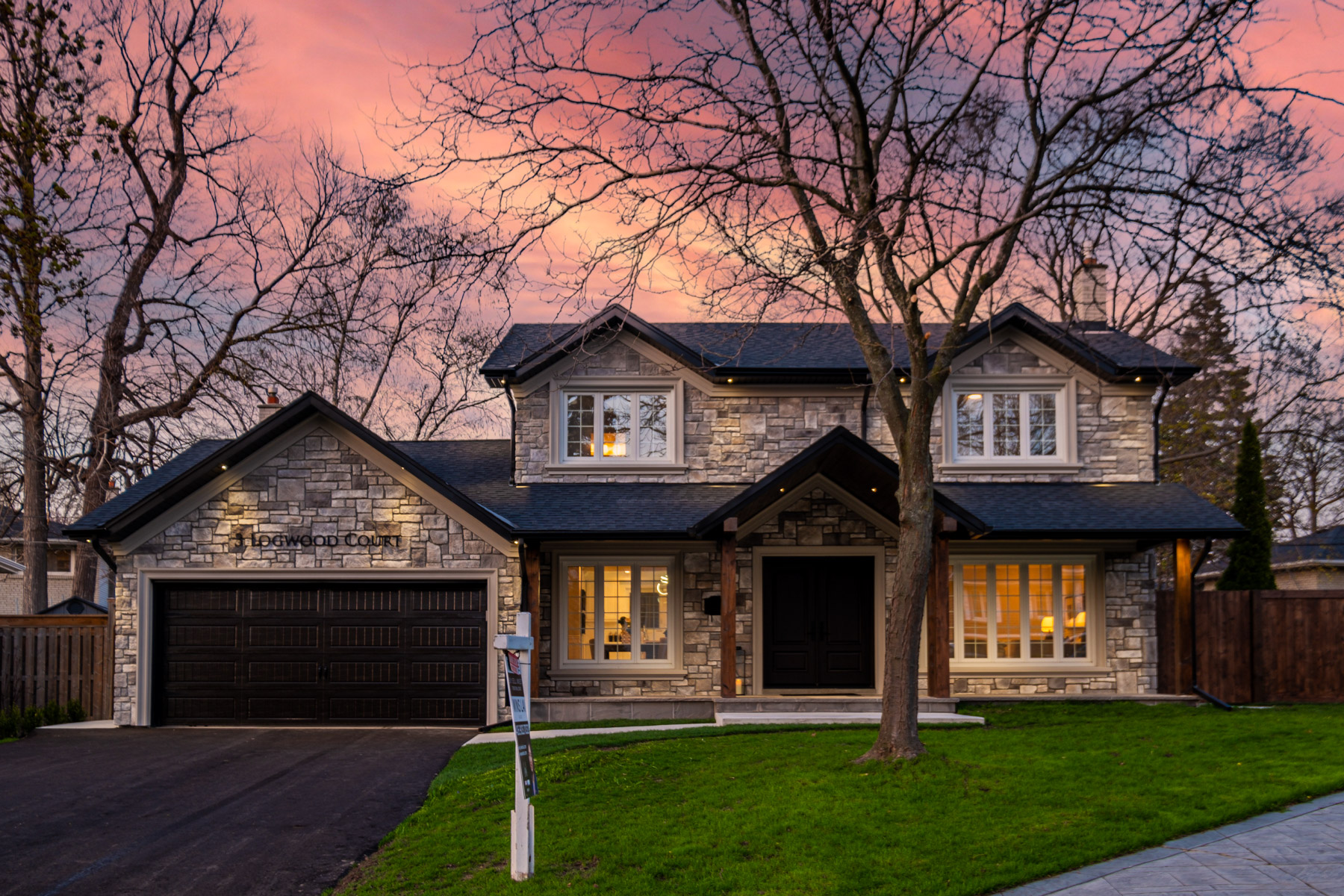 Evening photo of 3 Logwood Court, detached 2-storey house, under pink and purple skies.