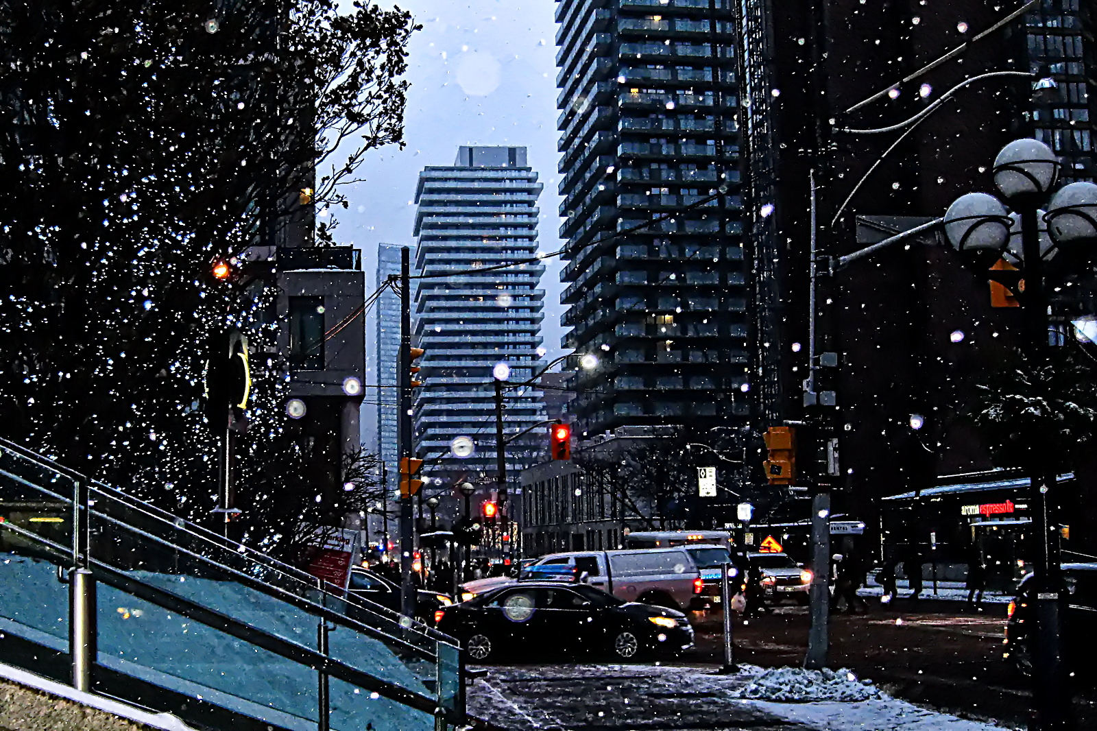 Photo of Toronto in winter and we see snow and buildings and cars and MLS.