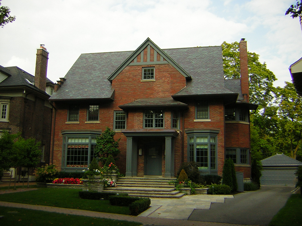 Redbrick mansion in Rosedale and also other houses on side.