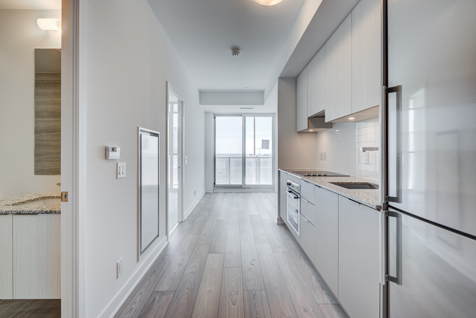 Condo with laminate floors and light gray walls.