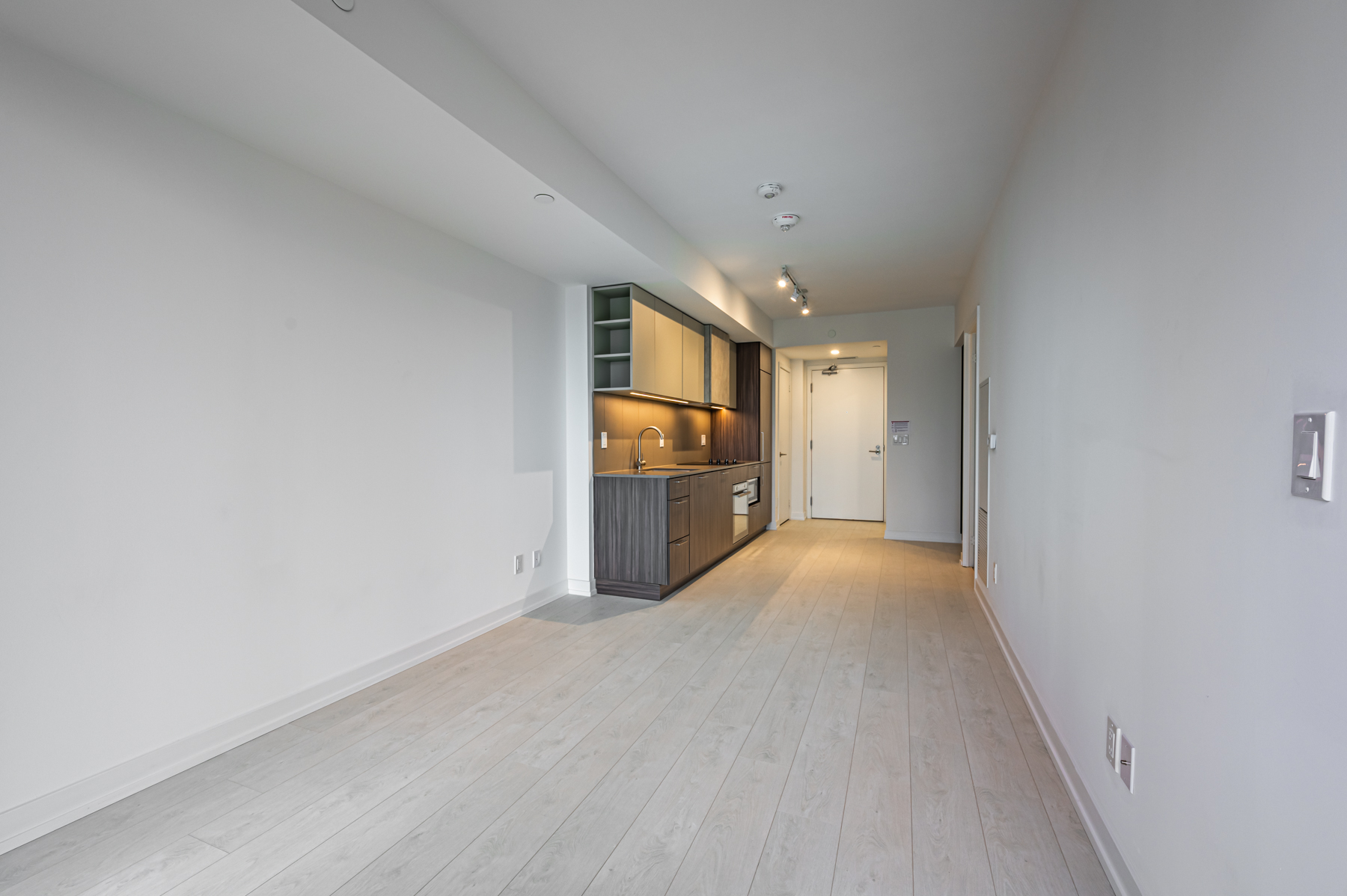 Empty living, dining and kitchen areas of 19 Western Battery Rd.