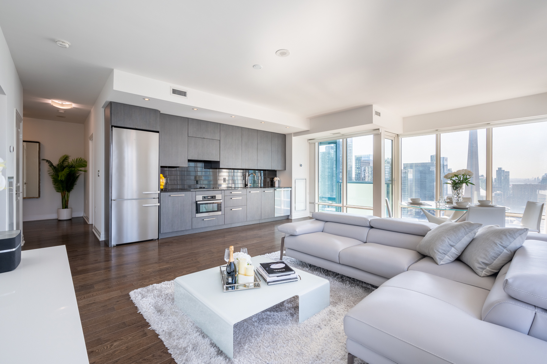 View of large condo living room and kitchen.