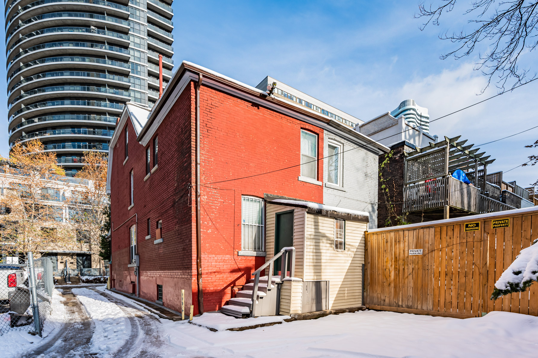 View of 27 Granby St from backyard showing large condo in background.