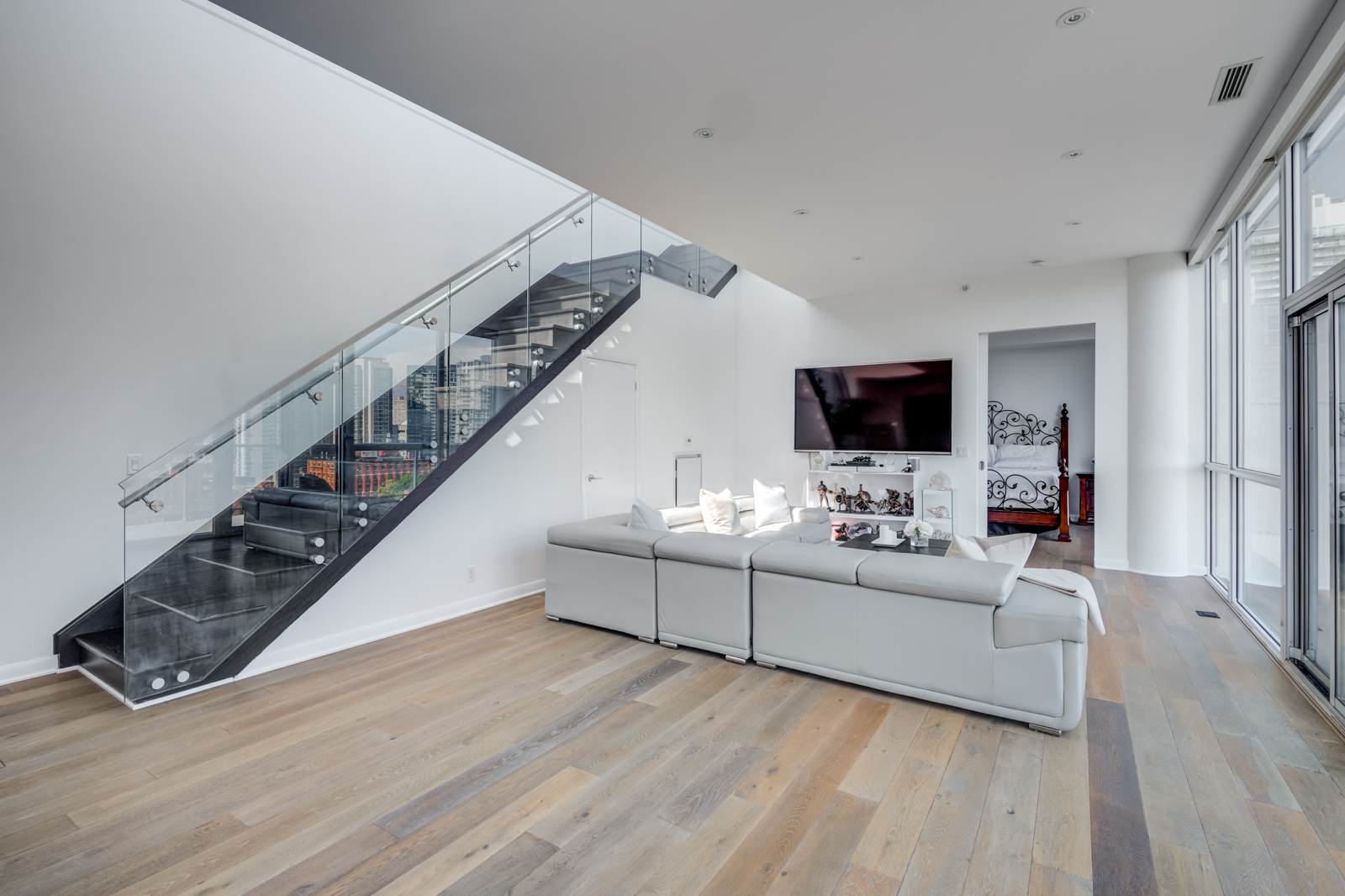 Glass staircase in Victory Lofts - 478 King St W Toronto Penthouse Suite.