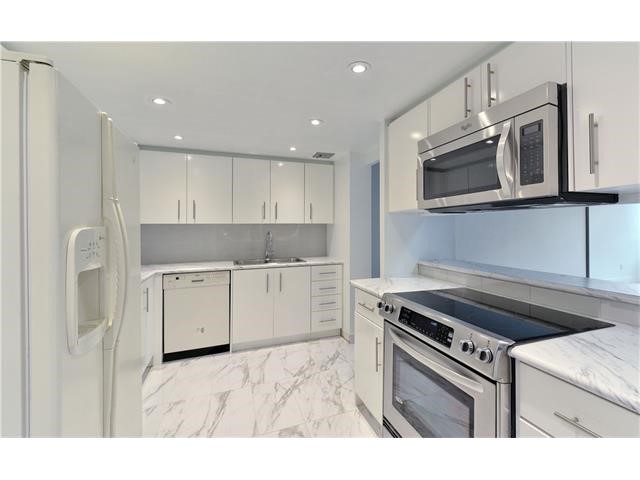 Image showing the kitchen area with new paint, potlights, and stainless steel appliances