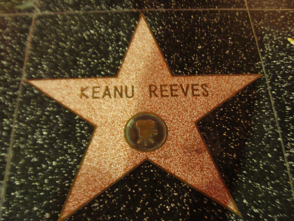 Photo of Keanu Reeves' Walk of Fame Star and black background.