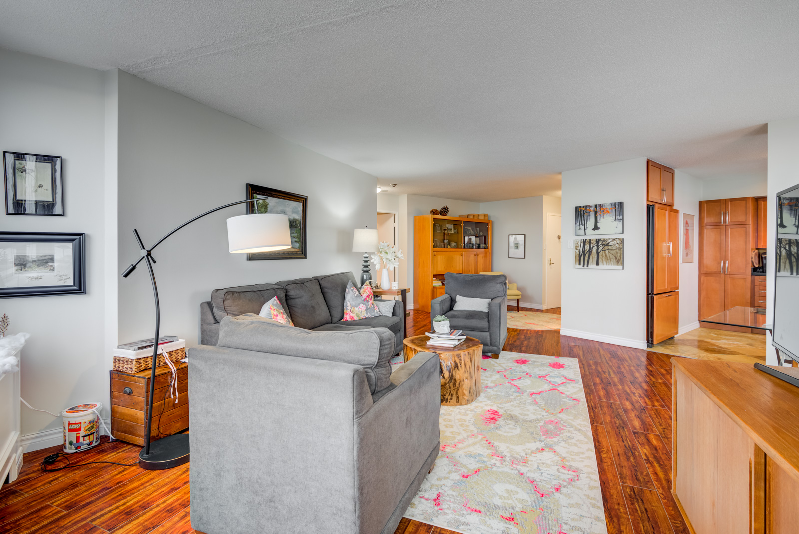 Bright reddish-orange laminate floors and gray walls of 260 Queens Quay W Unit 1202.